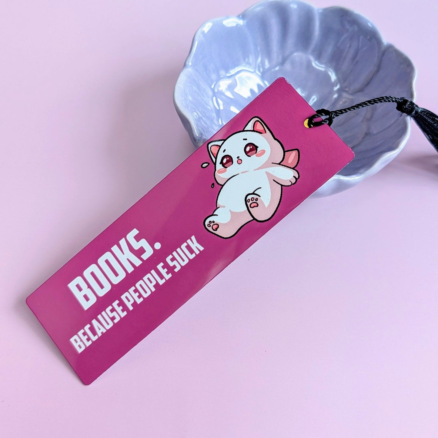 Pink bookmark with cartoon cat and text on a pink background