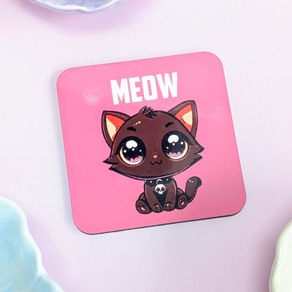 Pink coaster with a cartoon cat and 'MEOW' text on a light pink background