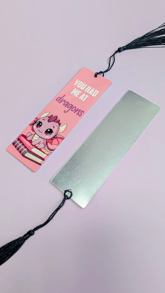 Two bookmarks with tassels on a light pink background