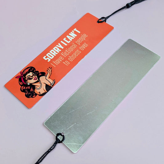Metallic bookmark with a colorful tag on a light gray background