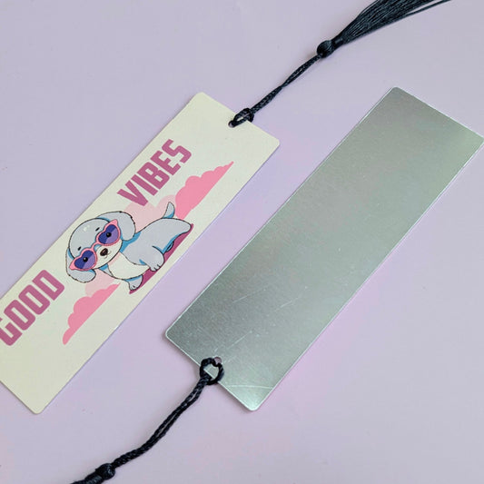 Bookmark with cartoon dog character and 'Good Vibes' text on a metallic surface