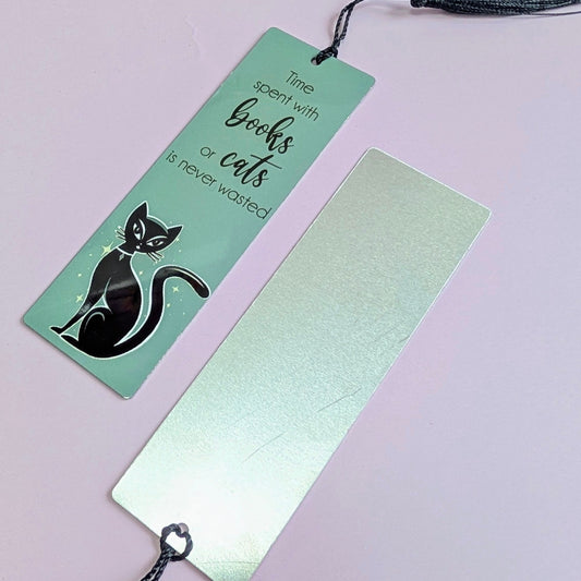 Two bookmarks with a black cat illustration on a light purple background